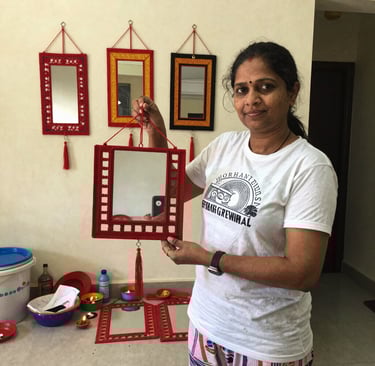 A group of women gathered outdoors, sharing stories and laughter while crafting vibrant textiles.