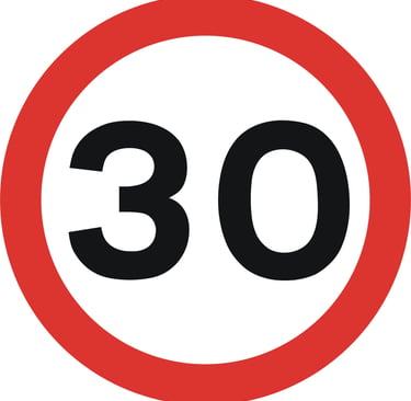 A circular road sign with a red border and the number 30 in black, indicating a 30 mph speed limit.