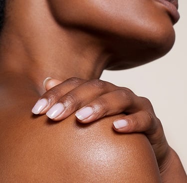 Close-up of woman’s smooth neck and shoulder skin highlighting healthy glow and aesthetic skincare