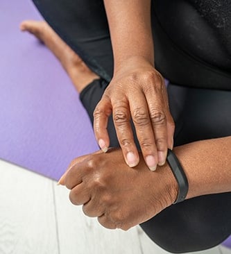 Close-up of person stretching wrist and hand during mobility exercise for pain relief and rehab
