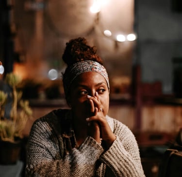 woman sitting and thoughtfully thinking about her relationship