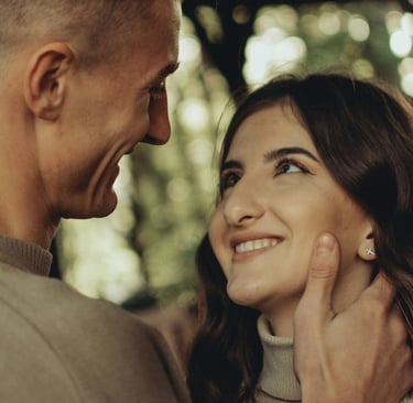 woman smiling softly looking at man who is looking at her with love