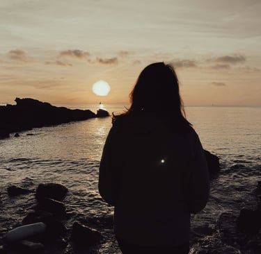 Woman looking out to sea and wondering if her ex misses her.