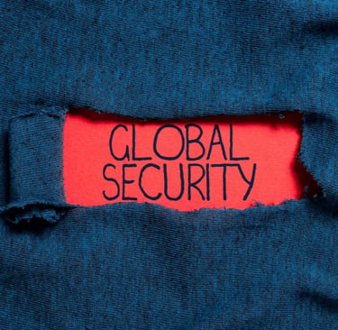 Blue fabric with a ripped hole with the text global security on a red paper.
