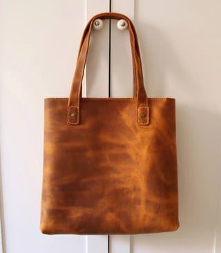 a brown leather tote bag with a leather tote bag