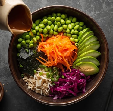 Healthy vegan poke bowl with edamame, avocado, carrots, and cabbage topped with savory dressing.