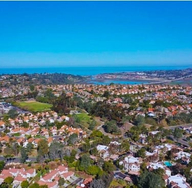 Aerial view of a coastal HOA suburban neighborhood with houses near south Carlsbad