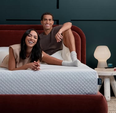 Couple lounging on a Leesa Sapira Hybrid Mattress