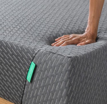 Tuft & Needle Mint Mattress hand leaning on mattress
