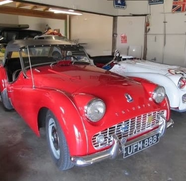 A red 1960 Triumph TR3A roadster.