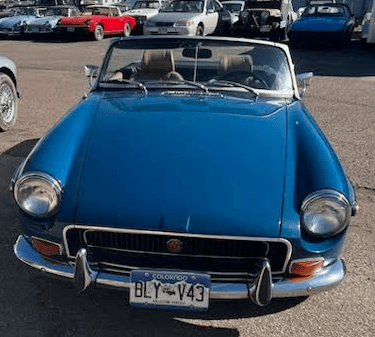 A front view of a blue MG MGB GT.