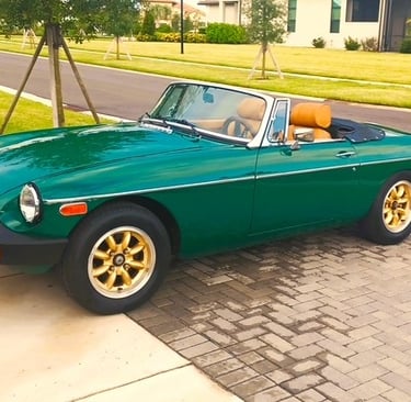 A sideview of a MG MGB roadster in British Racing Green.