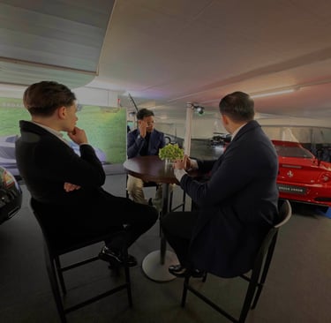 Well-dressed man inside a luxury car focused on planning and execution rather than consumption