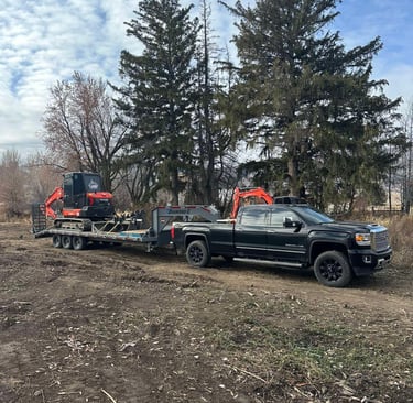JMB Earthwork's truck and trailer hauling equipment