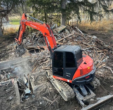 Kubota excavator demoing a residential structure