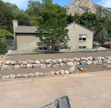 boulder wall and graded dirt at residential home