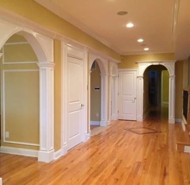 Custom arched openings and architectural columns in an NJ hallway