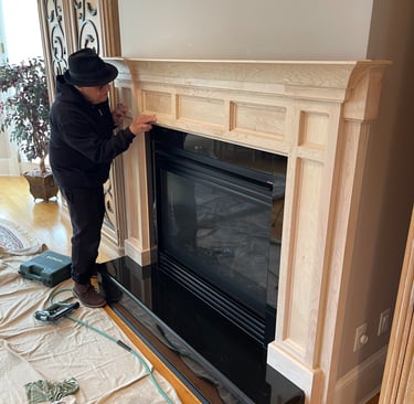 Gregory Christeas staining a custom wood fireplace mantel in a Monmouth County NJ home