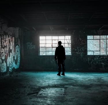 a person standing in a room with graffiti on the walls