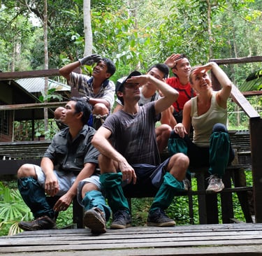  Traveller and guides sitting on a wooden deck resting while taking photos