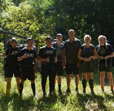 a group of people taking picture with the guide at the starting point of Maliau Basin trail