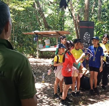 a jungle survival instructor is standing in front of a group of young student