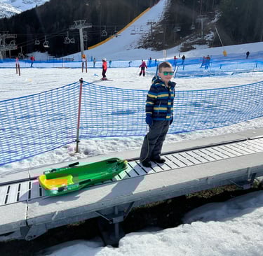 child sledging in la thuile