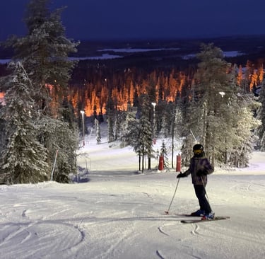 kids skiing in flood lit snow in ruka finland