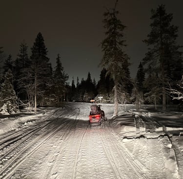 Snow mobiles in the night sky in Ruka Finland 