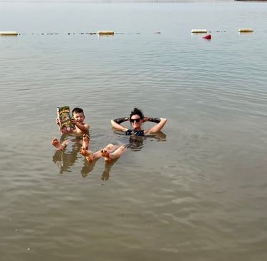 floating in the dead sea jordan with kids