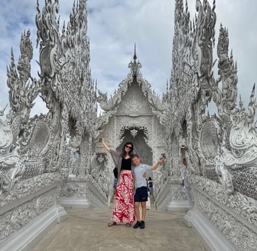 white temple in chaing rai thailand with families