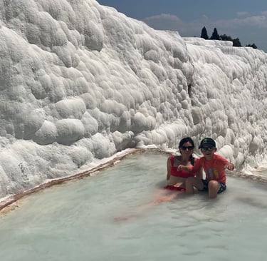 family swimming in pamukkale 