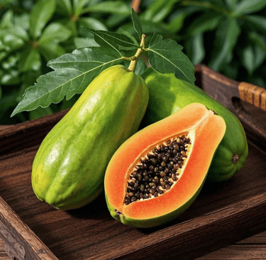 Fresh ripe papaya fruit halved with black seeds and green leaves on a rustic wooden tray.