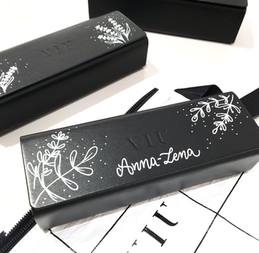 Custom black VIU eyewear cases featuring personalized hand-painted floral art and calligraphy.