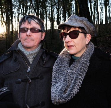 Couple in woods wearing sun glasses