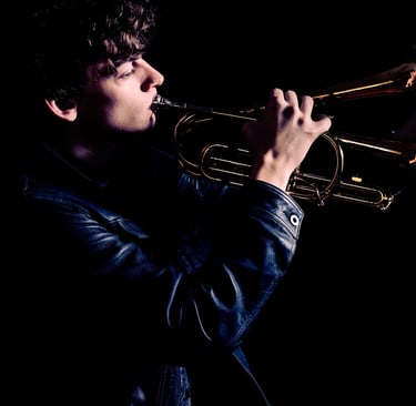 man playing trumpet in the dark
