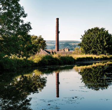 Factory chimney by canal