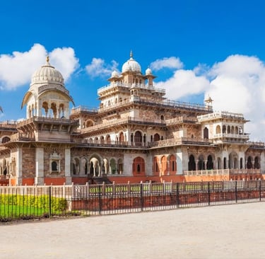 The Albert Hall Museum in Jaipur featuring Indo-Saracenic architecture under a bright blue sky.