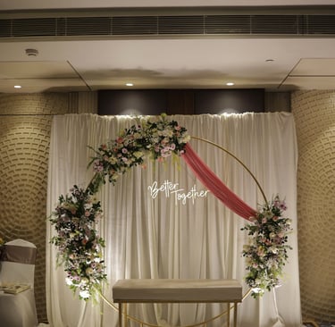 a wedding ceremony with a floral arch