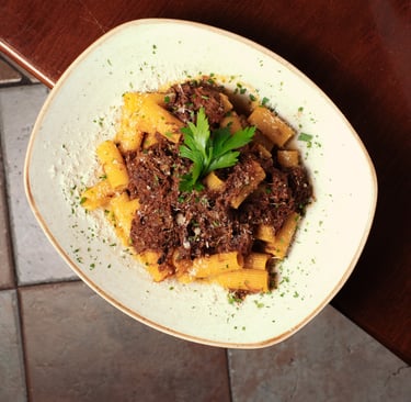 a bowl of pasta with meat and vegetables