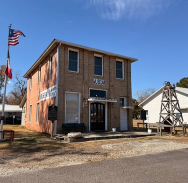 A brick building , museum of hardin county located in Kountze