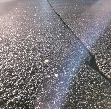 cracked pavement with chunks of salt on it