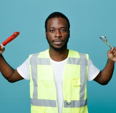 Professional plumber in a high-visibility vest holding a pipe wrench and spanner.