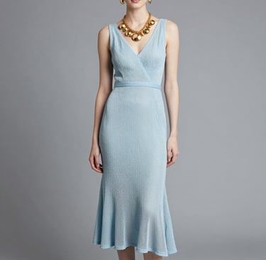 woman in blue dress standing