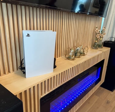 Modern wood slat entertainment center with blue electric fireplace.