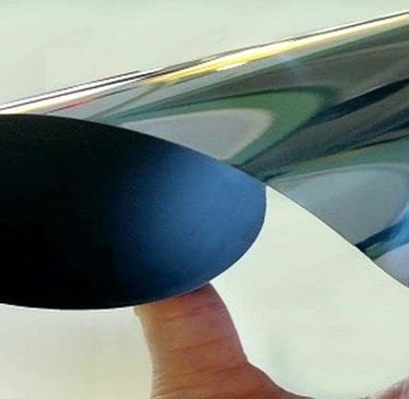 An ultra-thin silicon wafer is shown gently curved, revealing its smooth, reflective surface and ext