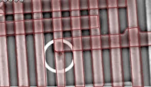 Optical micrograph of semiconductor RDL metal lines with highlighted defect.