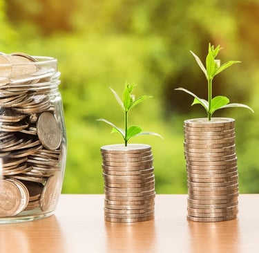 a jar of coins and a jar of coins with a plant growing out of it
