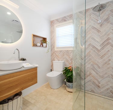 Modern private bathroom at Marche Home Stay with a floating vanity, mirror, rainfall shower, and warm natural finishes.