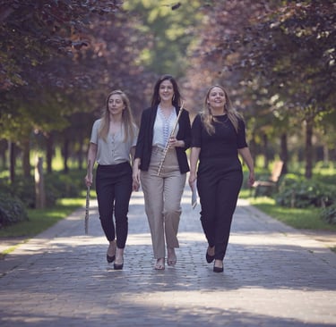 three women walking down a path in a park